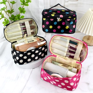 Set of three polka dot makeup bags showing interior storage and brush slots