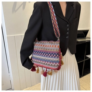 Bohemian woven crossbody bag with colorful geometric patterns and decorative tassels