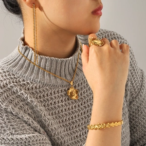 Elegant 18K gold-plated floral jewelry set with sun ring and tassel earrings on model