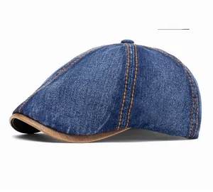 Detail of vintage denim beret featuring orange contrast stitching and brown leather trim