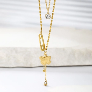 Detailed view of layered gold necklace with butterfly, paperclip and zircon pendants
