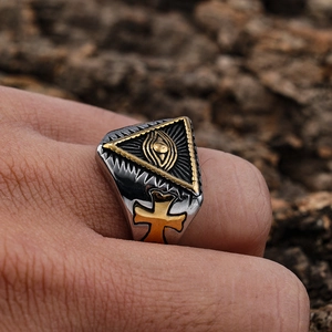 Close-up of All-Seeing Eye triangle ring with golden cross side relief and silver finish