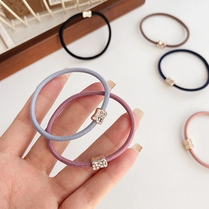 Elastic hair ties with rhinestones in various colors like blue, pink, and black