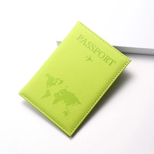 Close-up of lime green PU leather passport cover with embossed world map and airplane detail