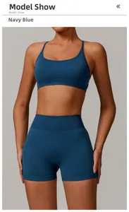 Navy blue seamless two-piece yoga set with strappy sports bra and high-waisted gym shorts