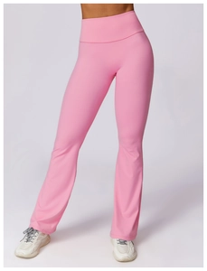 Detail view of pink high-waisted yoga flare pants with slit hem and stretch fabric