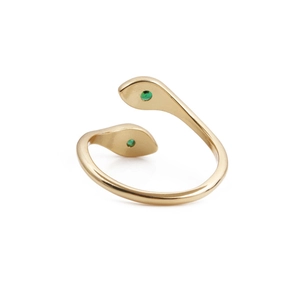 Detail of gold snake ring featuring green zircon eyes and intricate metal texture