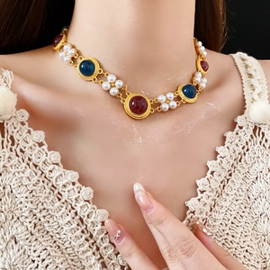 Vintage necklace with faux pearls and multicolor gems worn on a female model neck