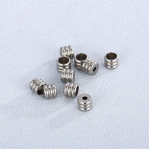 Macro shot of stainless steel beads with triple ring texture for DIY jewelry making
