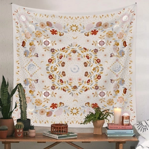 Detail of bohemian mandala tapestry featuring sun and moon motifs in a cozy home setting