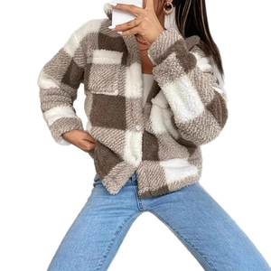Close-up of brown and white plaid fuzzy fleece jacket with textured grain plush fabric