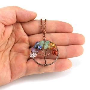 Antique copper tree of life necklace with amethyst and natural stones on a hand