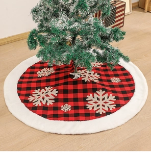 Macro view of red and black buffalo plaid Christmas tree skirt with plush white fur trim
