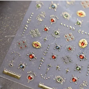 Macro shot of 3D embossed nail art stickers with gold sun and moon bohemian patterns