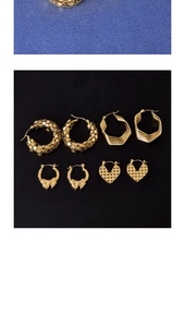 Detail view of gold earring set with rhombus, heart shapes and bowknot charms