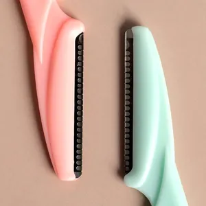Pink and green stainless steel eyebrow razors with safety mesh and plastic handles