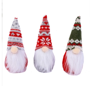 Detailed view of three plush Christmas gnomes with colorful knitted hats and white beards