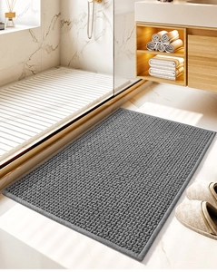 Detailed view of gray chenille bathroom mat with absorbent texture at shower entrance