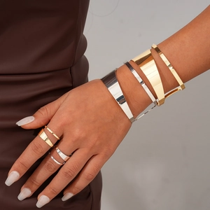 Minimalist metallic geometric open bracelet and ring set in polished gold and silver tones