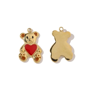 Detail of golden teddy bear pendant with red heart and brown enamel for DIY jewelry
