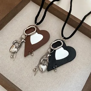 Leather heart puppy pendant necklace in brown and black with silver hardware charms