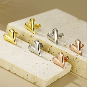 Three pairs of heart-shaped 18K gold-plated stainless steel earrings in assorted colors