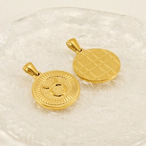 Golden 18K Taurus zodiac coin pendant showing front symbol and textured back view