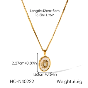 Detail view of gold sun heart pendant with white shell and dimensions for length and weight