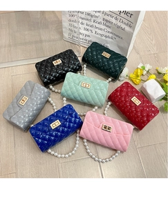 Detail of colorful quilted jelly bags with pearl handles and gold rotating locks