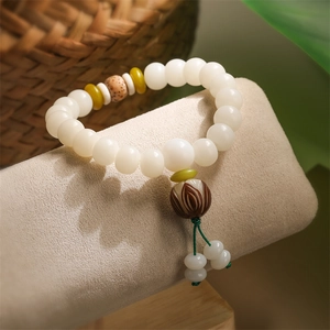 White bodhi root beaded bracelet with yellow spacer beads and carved lotus pendant