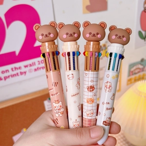 Detail of four cute cartoon bear multi-color ballpoint pens with decorative tops