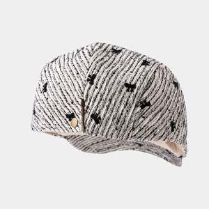Classic black and white tweed newsboy cap with elegant small bow patterns and metal buckle
