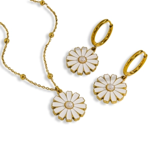Golden daisy jewelry set with white enamel petals and pearl center on white background