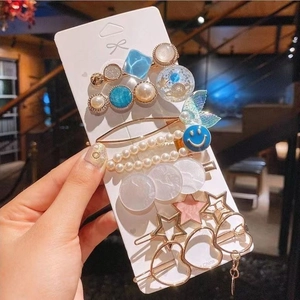 Detail of assorted pearl and rhinestone hair clip set on display card with diverse styles