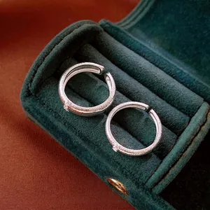 Retro brushed silver open rings with zircon stones displayed in a green velvet jewelry box