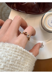 Detail of vintage bicolor chain ring in light blue and amber resin on hand
