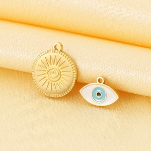 18K gold plated evil eye and sun charms on golden satin for jewelry making