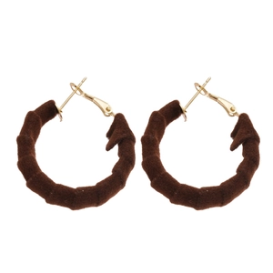 Minimalist dark brown flocked hoop earrings with golden metal clasps on white background