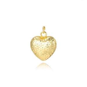 Detailed close-up of a 18k gold heart pendant with a unique hammered texture finish