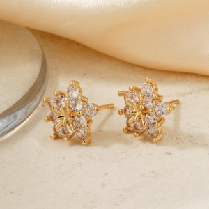 Exquisite gold snowflake earrings featuring geometric cubic zirconia stones in a luxury setting