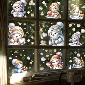 Christmas window stickers featuring cartoon snowmen and snowflakes on glass with wood frame