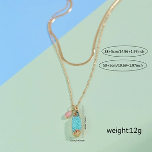 Double-layered gold necklace with blue water-drop gemstone pendant and pink beads