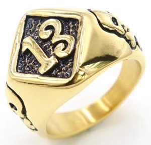 Macro detail of vintage gold ring featuring number 13 and skull engraving on side
