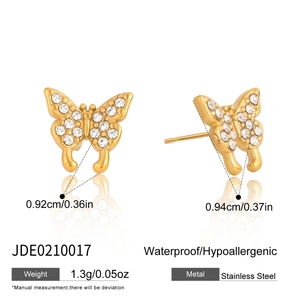 Detail of 18K gold stainless steel butterfly stud earrings with white cubic zirconia