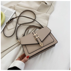 Detailed view of beige PU leather crossbody bag with gold metal buckle and shoulder strap