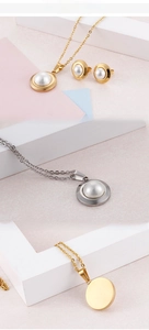 Detail view of round pearl jewelry set with gold and silver plated finish and stud earrings