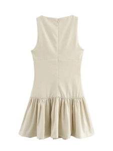 Detail of the back hidden zipper and pleated skirt on a beige sleeveless dress