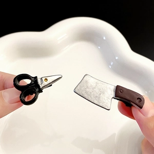 Macro shot of creative scissors and chef knife hairpins with realistic metallic textures