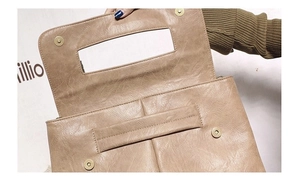 Detail view of the khaki brown PU leather flap bag with magnetic snap and rectangular handle