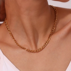 Detail of 5mm gold plated stainless steel Figaro chain necklace worn by a model